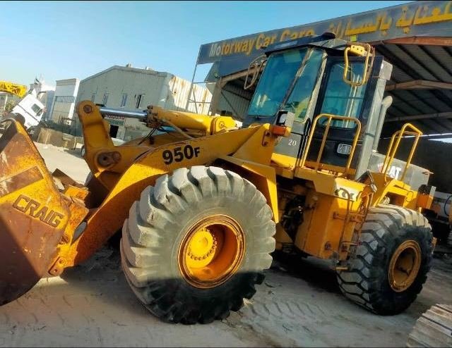 Caterpillar 950F wheel loader with bucket attachment in the Axom Transport Mussafah yard