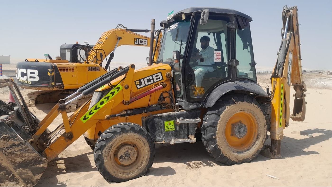 Certified operator working an Axom Transport JCB 3CX backhoe loader with a JCB tracked excavator behind