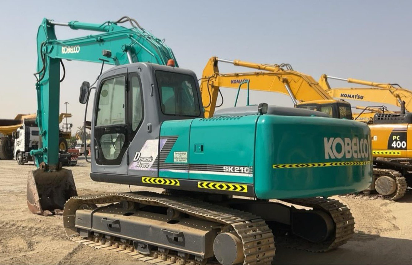 Kobelco crawler excavator working alongside a Caterpillar wheel loader on an Abu Dhabi earthworks site